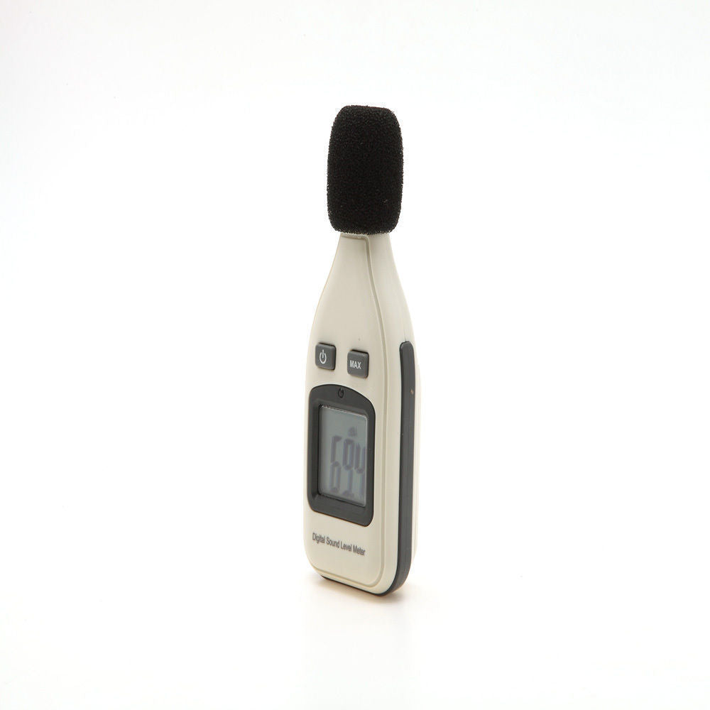 A handheld digital sound level meter with a black microphone cover, buttons, and a digital display showing a reading.