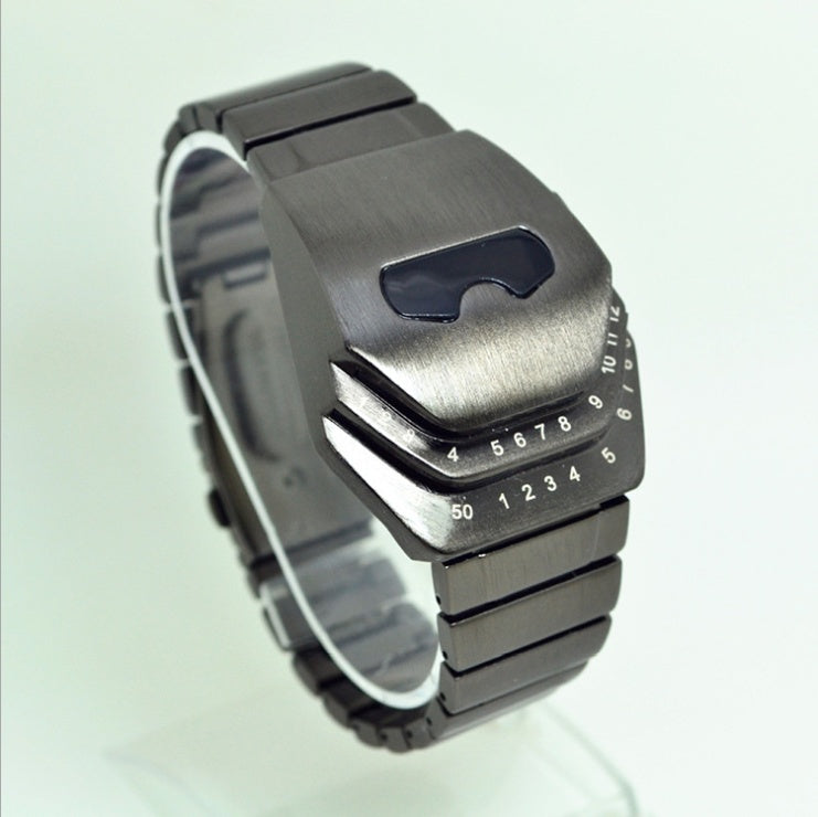 A digital men's watch with a blue-lit number display, alloy strap, and diamond-shaped dial.