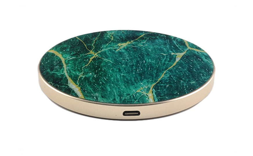 A collection of wireless chargers with a circular design, available in white, black, and green colors, with a marble pattern and a gold edge.