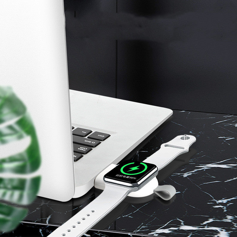 A white wireless charger mounted on a wall, charging a white Apple Watch.