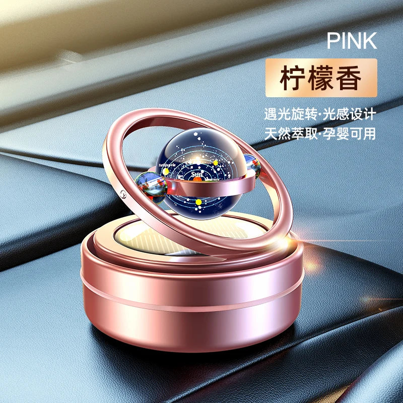 A car oil diffuser with a solar system theme, featuring a rotating globe on top, Pink.
