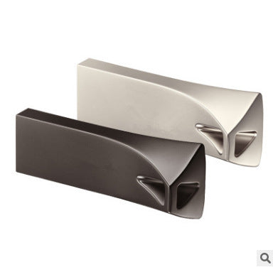 Two triangle-shaped USB flash drives, one silver and one black, against a blue background.