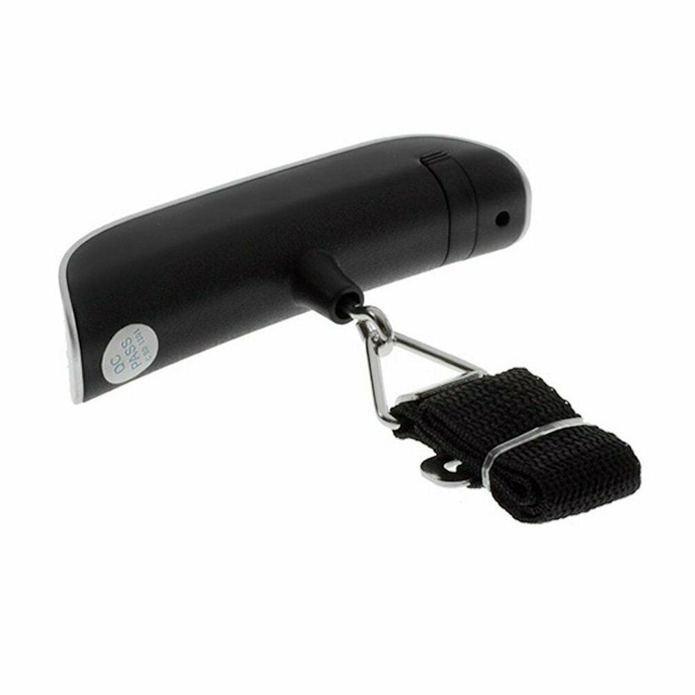 A hand holding a black luggage scale with a green LCD screen displaying weight, featuring a hook and button for operation.