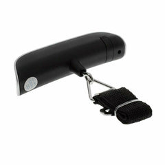A hand holding a black luggage scale with a green LCD screen displaying weight, featuring a hook and button for operation.