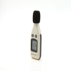A handheld digital sound level meter with a black microphone cover, buttons, and a digital display showing a reading.