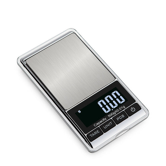 A mini portable scale with a stainless steel surface and a digital LCD display.