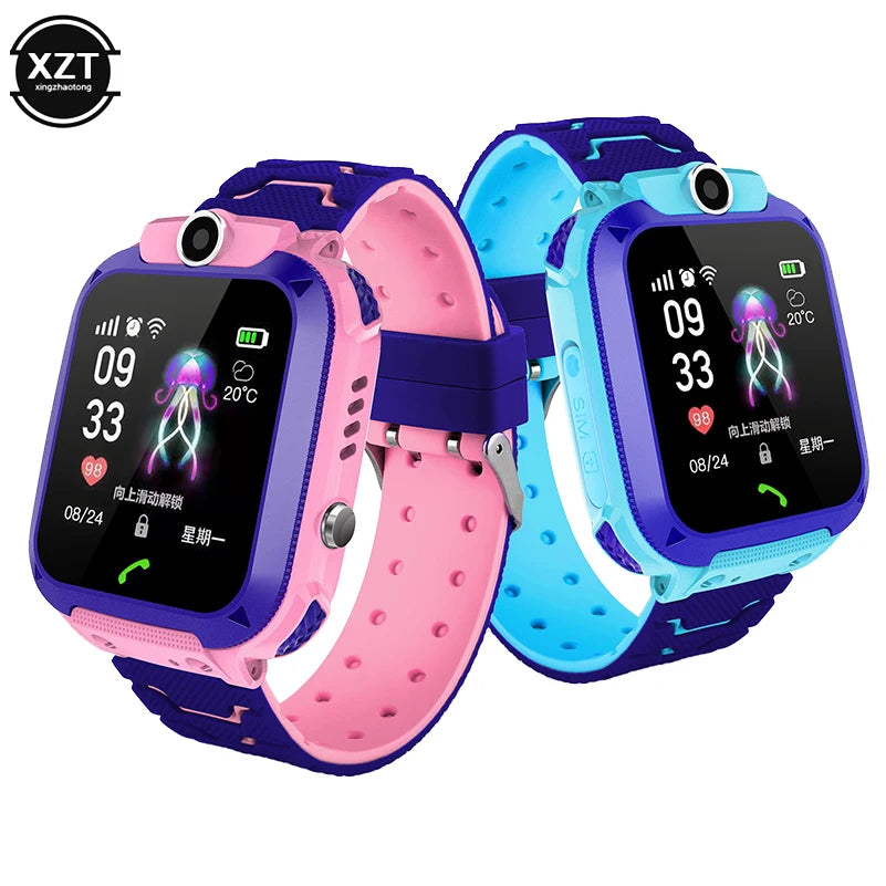 Two children's smart watches, one in pink and one in blue, with a silicone band and a square touchscreen display.