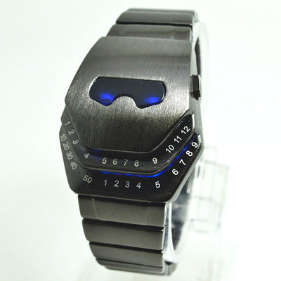 A digital men's watch with a blue-lit number display, alloy strap, and diamond-shaped dial.