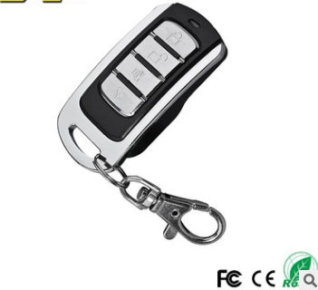 A black universal multi-programmable remote control with four buttons and a keychain.