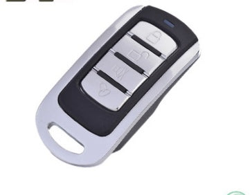 A black universal multi-programmable remote control with four buttons and a keychain.
