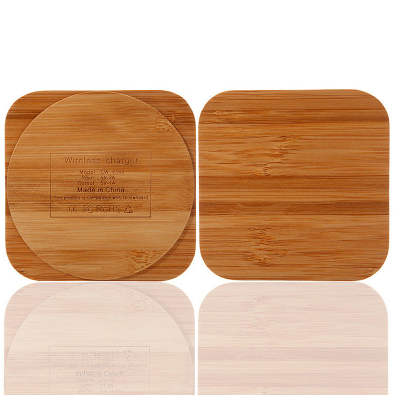 A wooden bamboo wireless charger with a USB port, in a square shape.