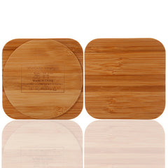 A wooden bamboo wireless charger with a USB port, in a square shape.