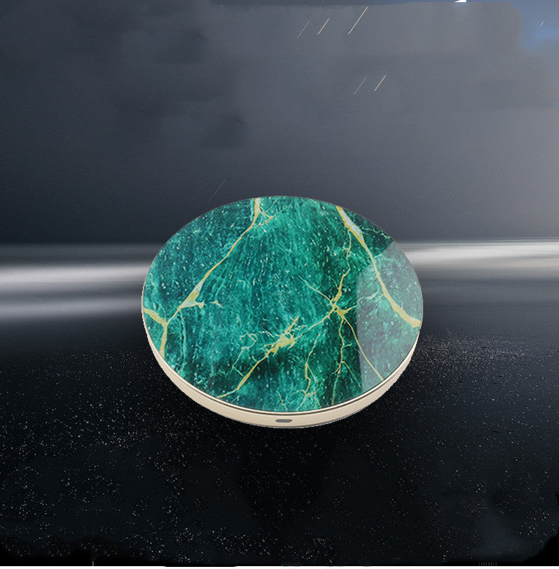 A collection of wireless chargers with a circular design, available in white, black, and green colors, with a marble pattern and a gold edge.