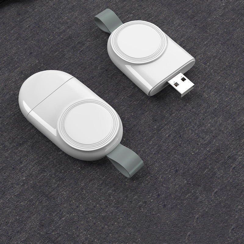 A white wireless charger mounted on a wall, charging a white Apple Watch.