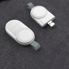 A white wireless charger mounted on a wall, charging a white Apple Watch.